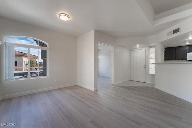7400 W Flamingo Rd Unit 2013, Las Vegas, NV 89147 - unfurnished living room featuring light wood-style flooring and baseboards