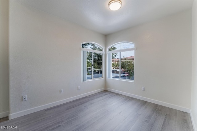 spare room with hardwood / wood-style flooring