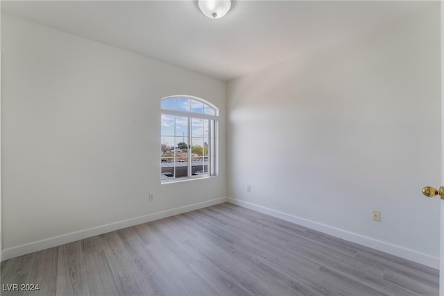 empty room with light hardwood / wood-style flooring