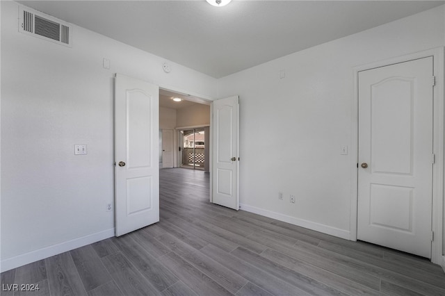 unfurnished room featuring hardwood / wood-style flooring