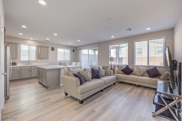 living area featuring recessed lighting, visible vents, and light wood finished floors