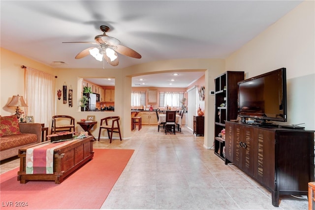 living room with light tile patterned floors and ceiling fan