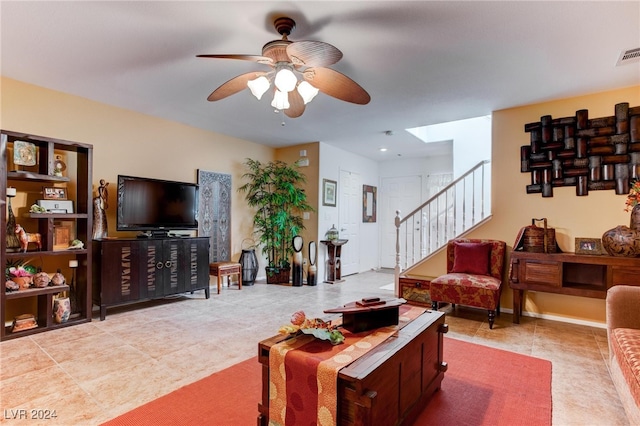 living room with light tile patterned flooring and ceiling fan