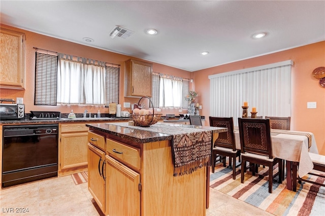 kitchen featuring light brown cabinets, black dishwasher, dark stone countertops, a center island, and light tile patterned floors