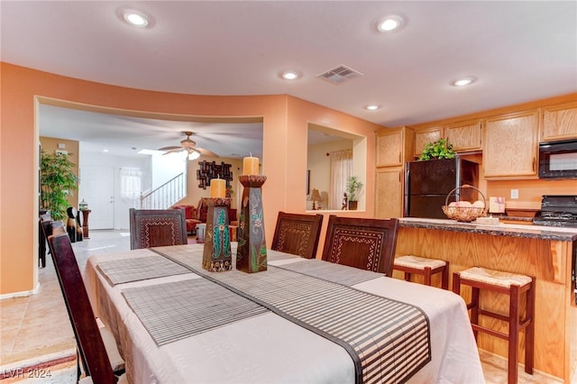 tiled dining area featuring ceiling fan