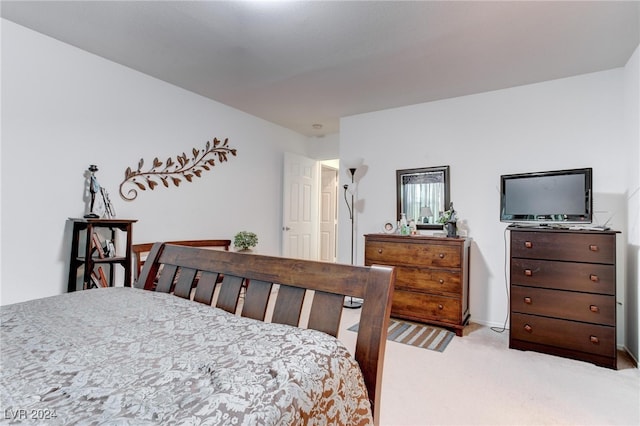 bedroom featuring light carpet