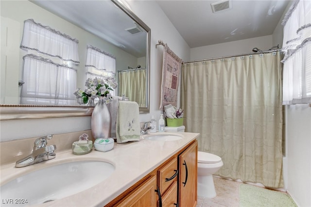 full bathroom featuring vanity, shower / tub combo, toilet, and plenty of natural light