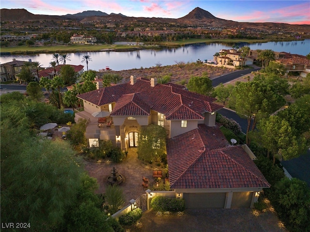 aerial view at dusk with a water and mountain view