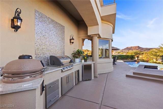 view of patio / terrace featuring a mountain view and area for grilling