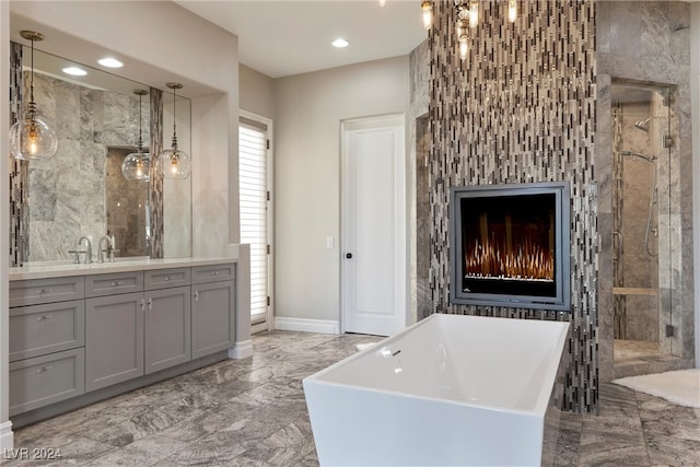 bathroom featuring vanity, separate shower and tub, and a fireplace