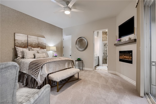 carpeted bedroom featuring ensuite bathroom and ceiling fan