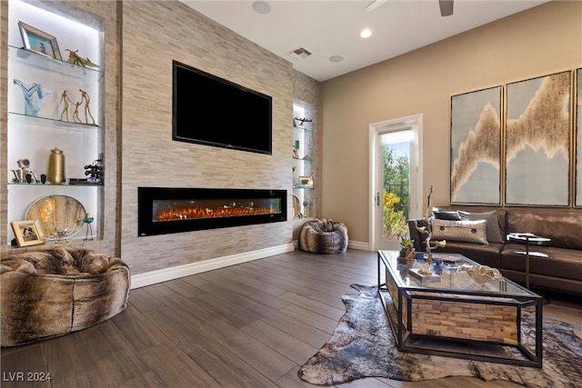 living room with hardwood / wood-style flooring and a large fireplace