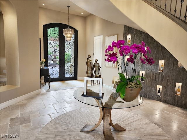 foyer entrance with french doors and a high ceiling