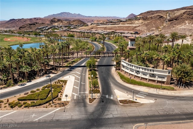 birds eye view of property with a water and mountain view