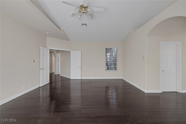 spare room featuring dark wood-type flooring, ceiling fan, and vaulted ceiling