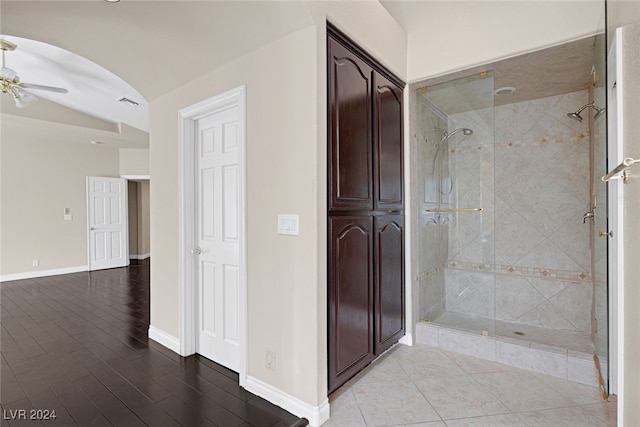 bathroom featuring an enclosed shower, wood-type flooring, ceiling fan, and vaulted ceiling