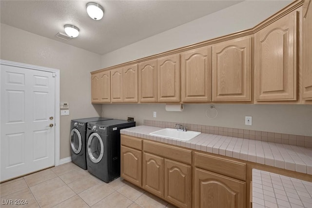 1931 Fox Canyon Cir, Las Vegas, NV 89117 - laundry room with separate washer and dryer, cabinet space, and light tile patterned flooring