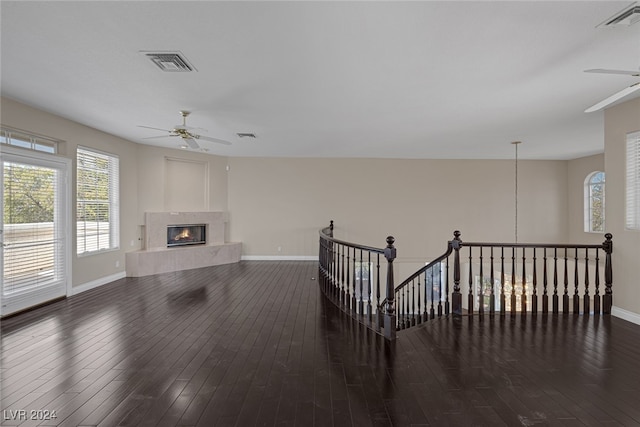 living room featuring dark wood-type flooring and ceiling fan