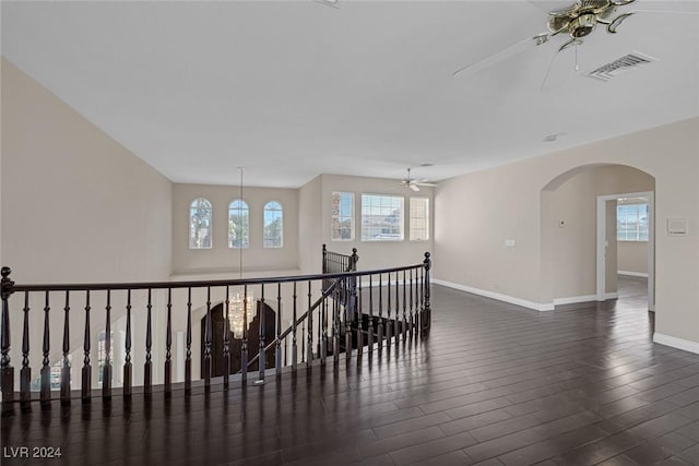 1931 Fox Canyon Cir, Las Vegas, NV 89117 - corridor with wood finished floors, baseboards, arched walkways, and an upstairs landing