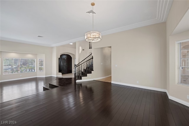 interior space with ornamental molding, wood-type flooring, and a notable chandelier