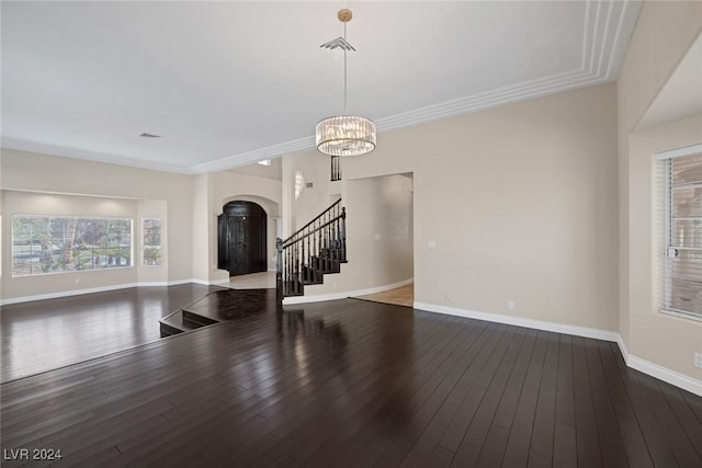 1931 Fox Canyon Cir, Las Vegas, NV 89117 - unfurnished living room featuring arched walkways, stairway, baseboards, wood-type flooring, and ornamental molding
