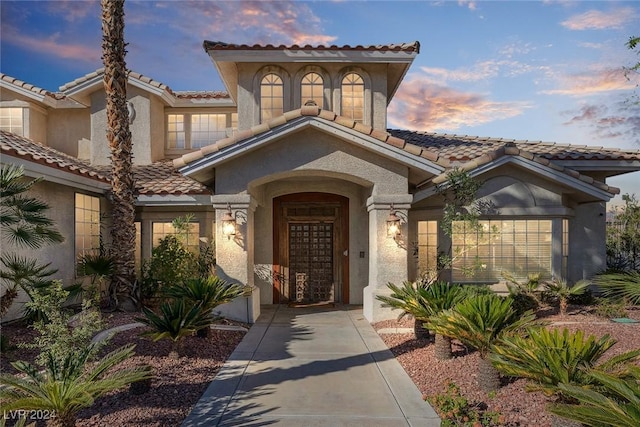 1931 Fox Canyon Cir, Las Vegas, NV 89117 - view of exterior entry with a tiled roof and stucco siding