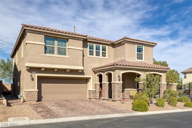 mediterranean / spanish home featuring a garage