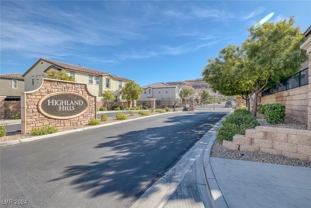 6370 Ava Ridge Ave, Las Vegas, NV 89141 - view of asphalt road featuring a residential view, curbs, a gate, and a gated entry