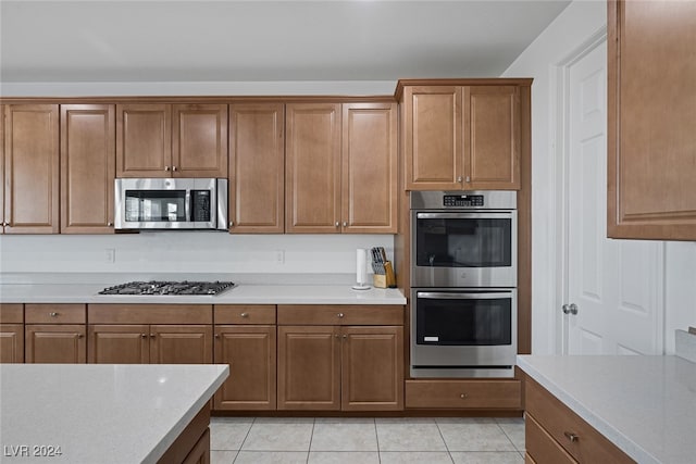 kitchen with appliances with stainless steel finishes and light tile patterned flooring