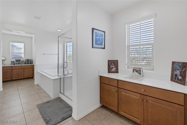 bathroom with vanity, plus walk in shower, and tile patterned flooring