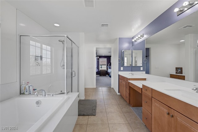 bathroom featuring vanity, independent shower and bath, and tile patterned flooring