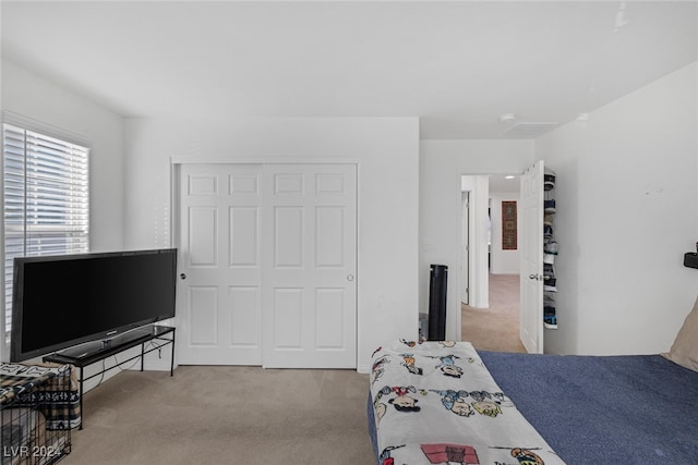 carpeted bedroom with a closet