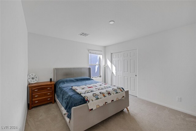 carpeted bedroom with a closet