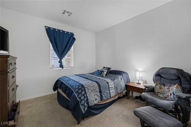 bedroom with light colored carpet