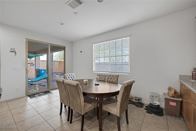 tiled dining space with a wealth of natural light