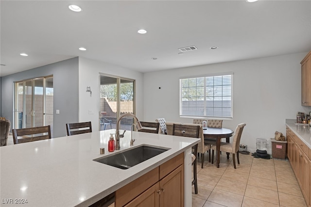 kitchen with sink and light tile patterned flooring