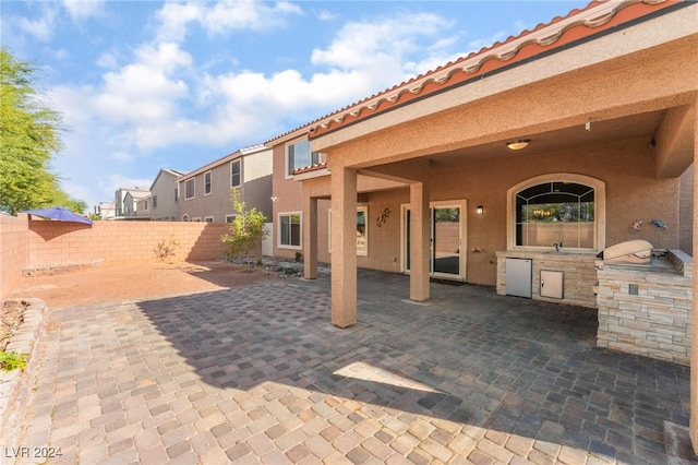 view of patio with area for grilling and sink