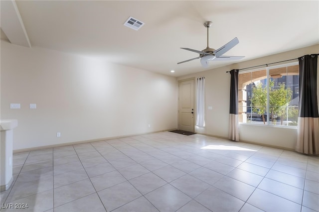 tiled empty room featuring ceiling fan