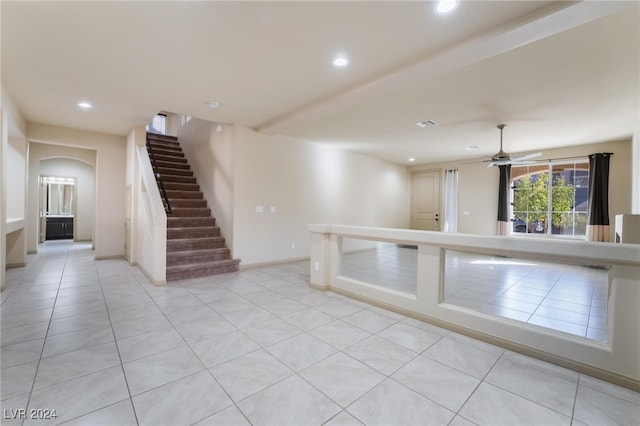 interior space featuring light tile patterned flooring and ceiling fan