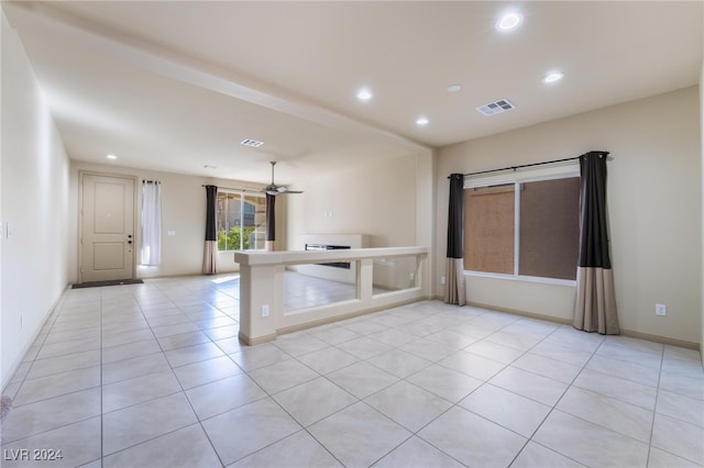 tiled empty room with ceiling fan