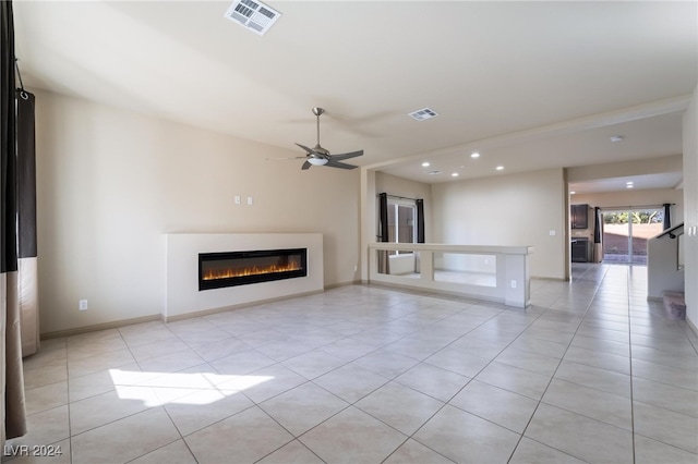 unfurnished living room with light tile patterned floors and ceiling fan