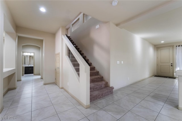 stairway with tile patterned floors