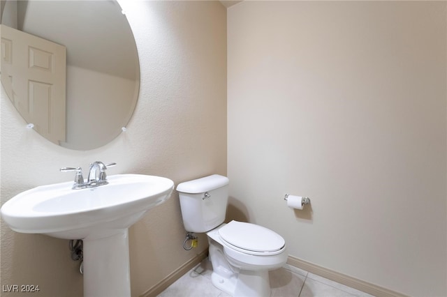 bathroom with toilet and tile patterned flooring