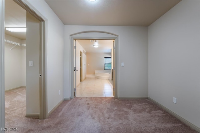 hallway featuring light colored carpet