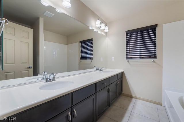 bathroom featuring vanity, tile patterned flooring, and a bathing tub