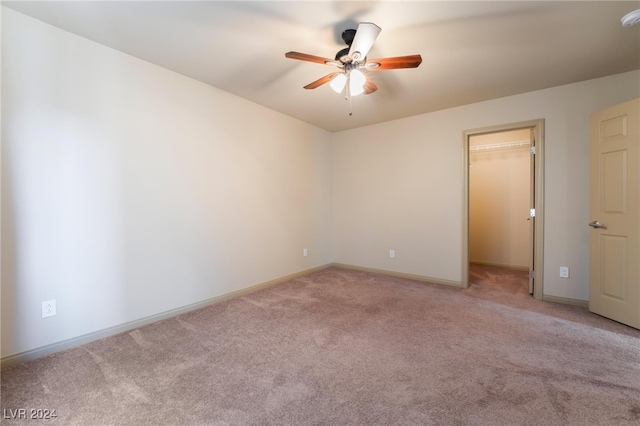 unfurnished room with carpet and ceiling fan