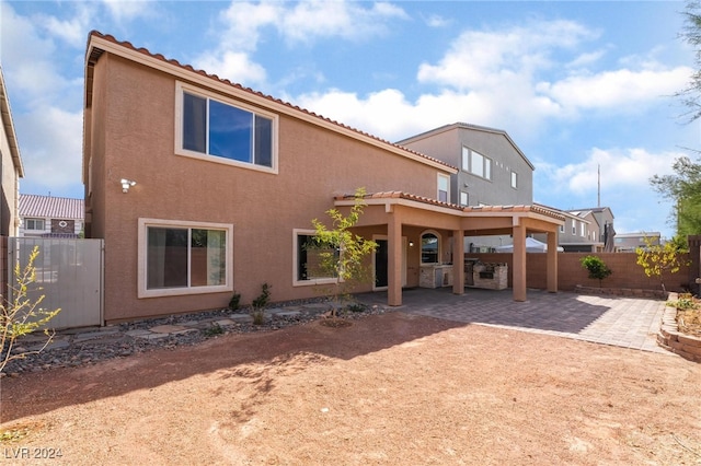 back of house with a patio area