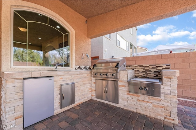 view of patio with sink, area for grilling, and grilling area