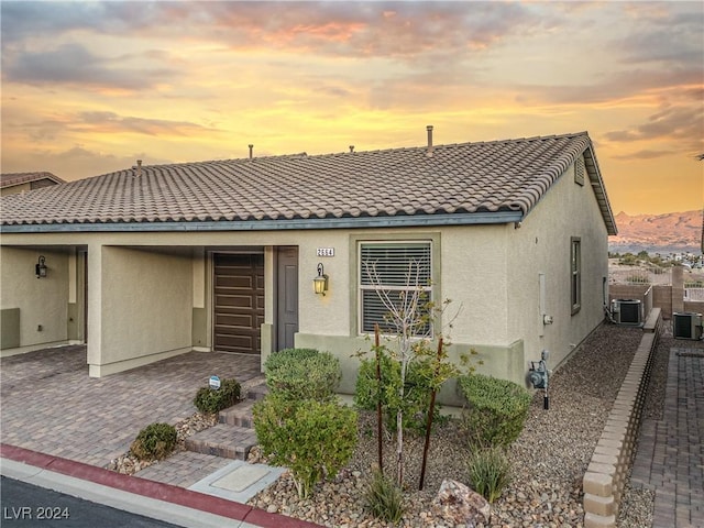 2664 Chinaberry Hill St, Laughlin, NV 89029 - view of front facade featuring stucco siding, cooling unit, a tiled roof, and a patio
