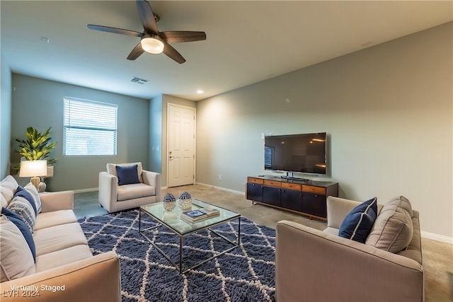 living room featuring ceiling fan and carpet